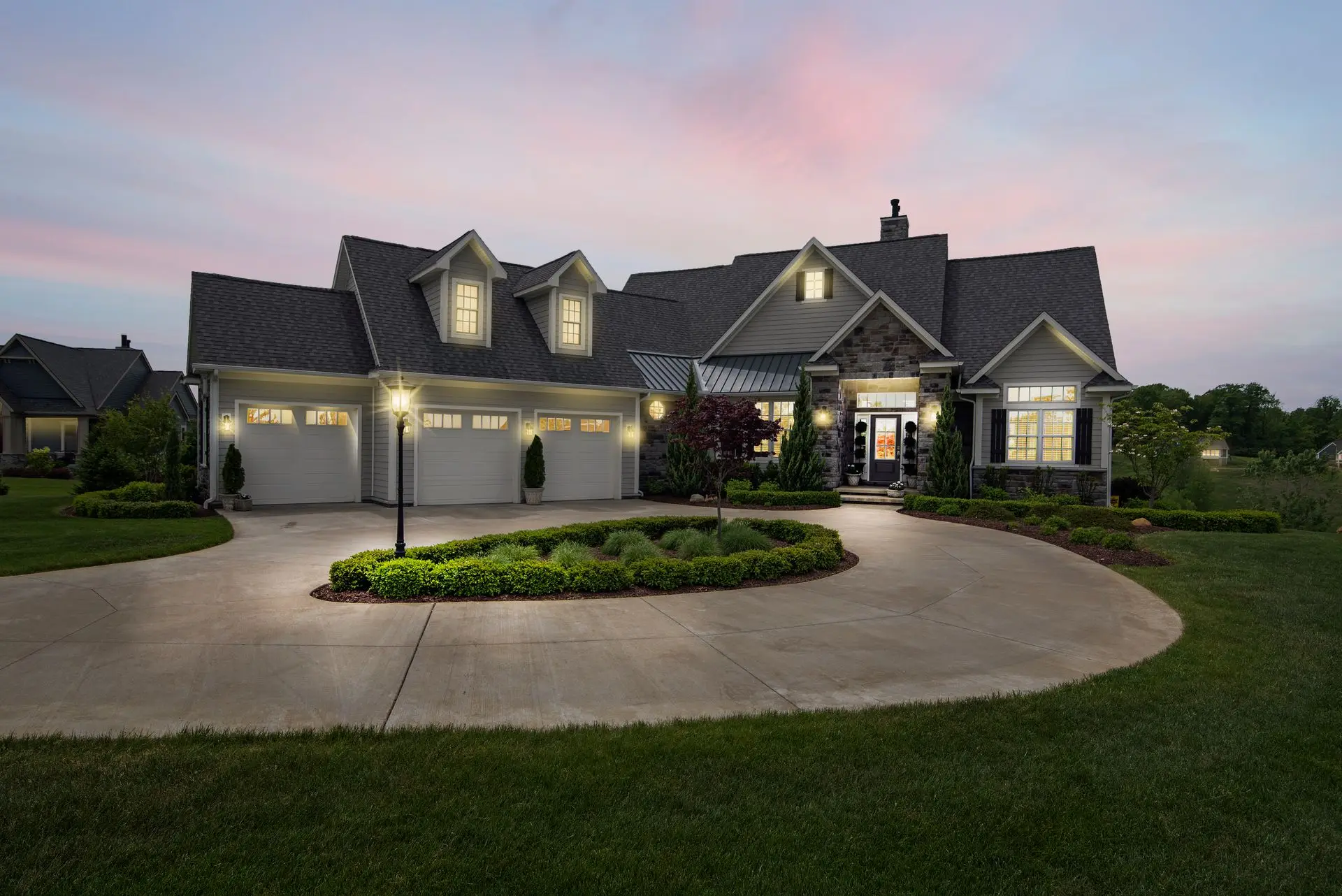 Luxury residential home lit at dusk