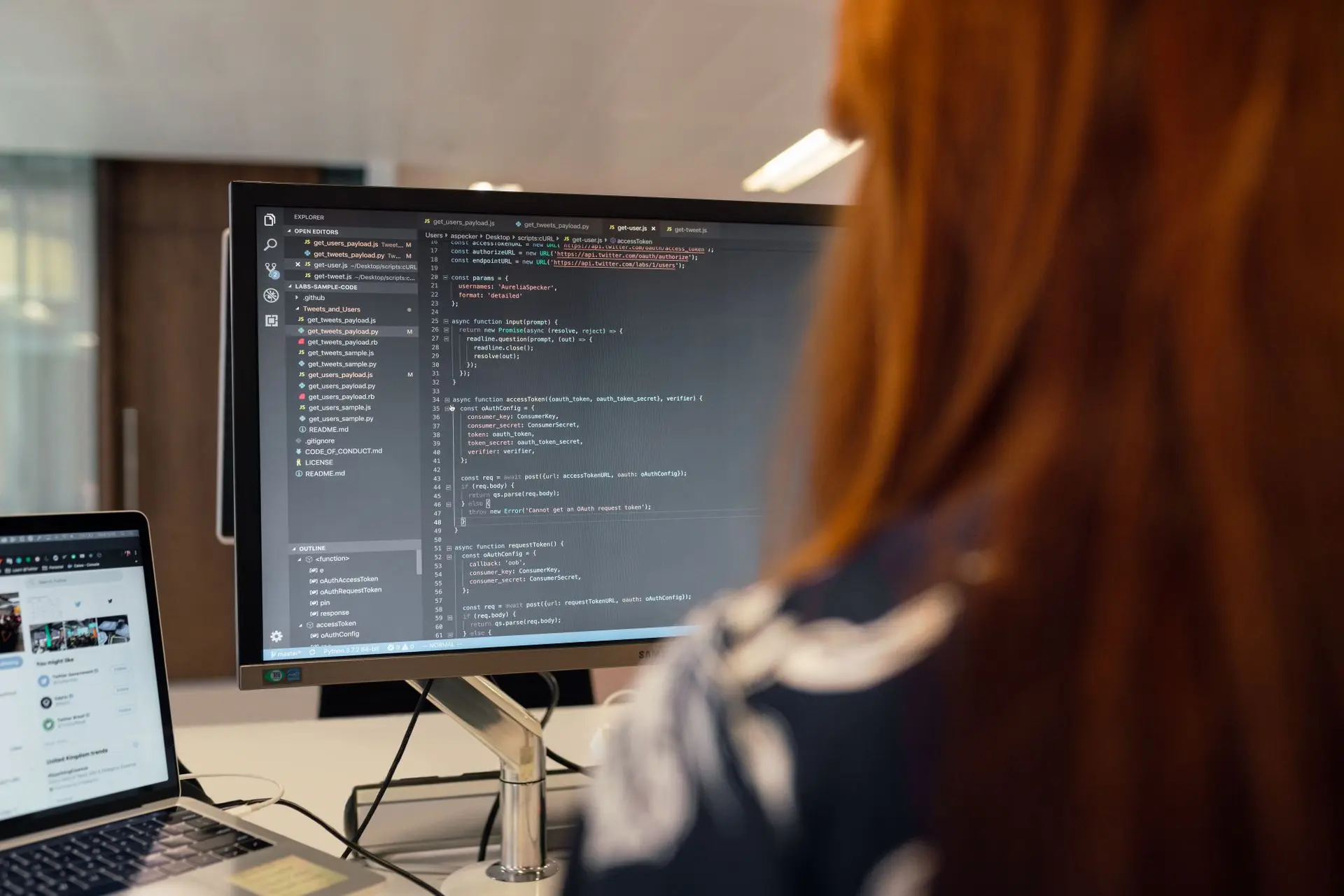 Software developer working with code on screen